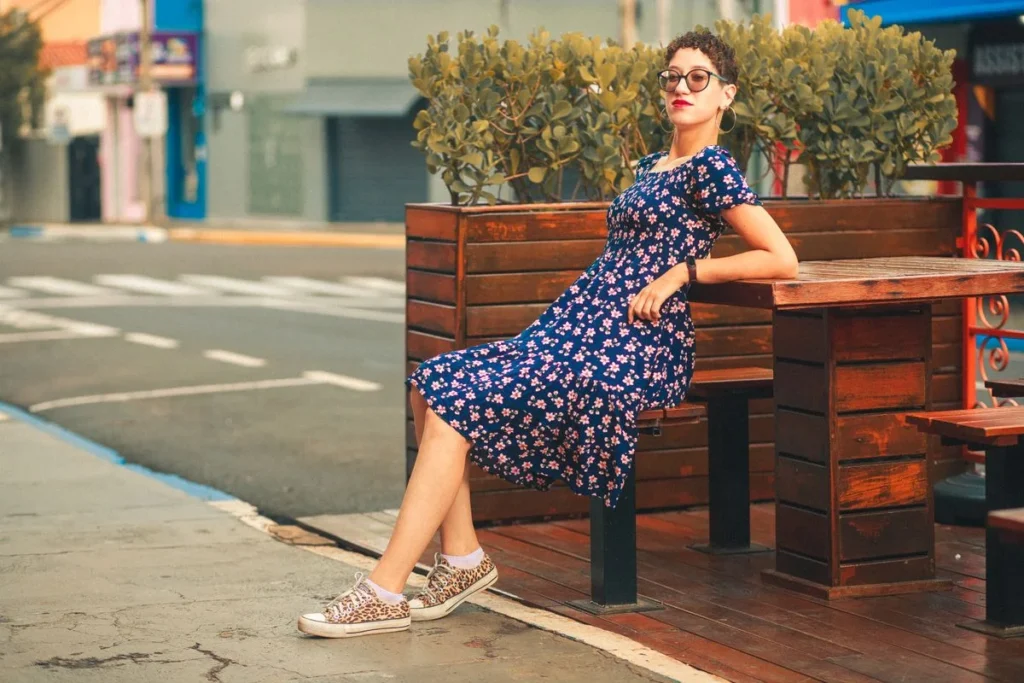 Woman in a floral sundress relaxing outdoors on a warm day