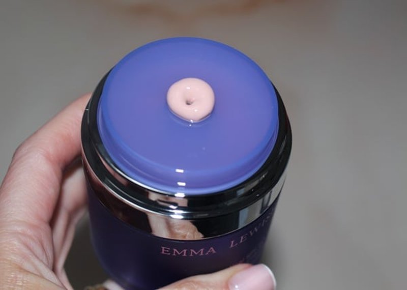 Creamy light-pink SPF texture swiped from the jar lid