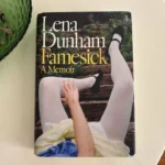 Famesick book cover by Lena Dunham on a white table